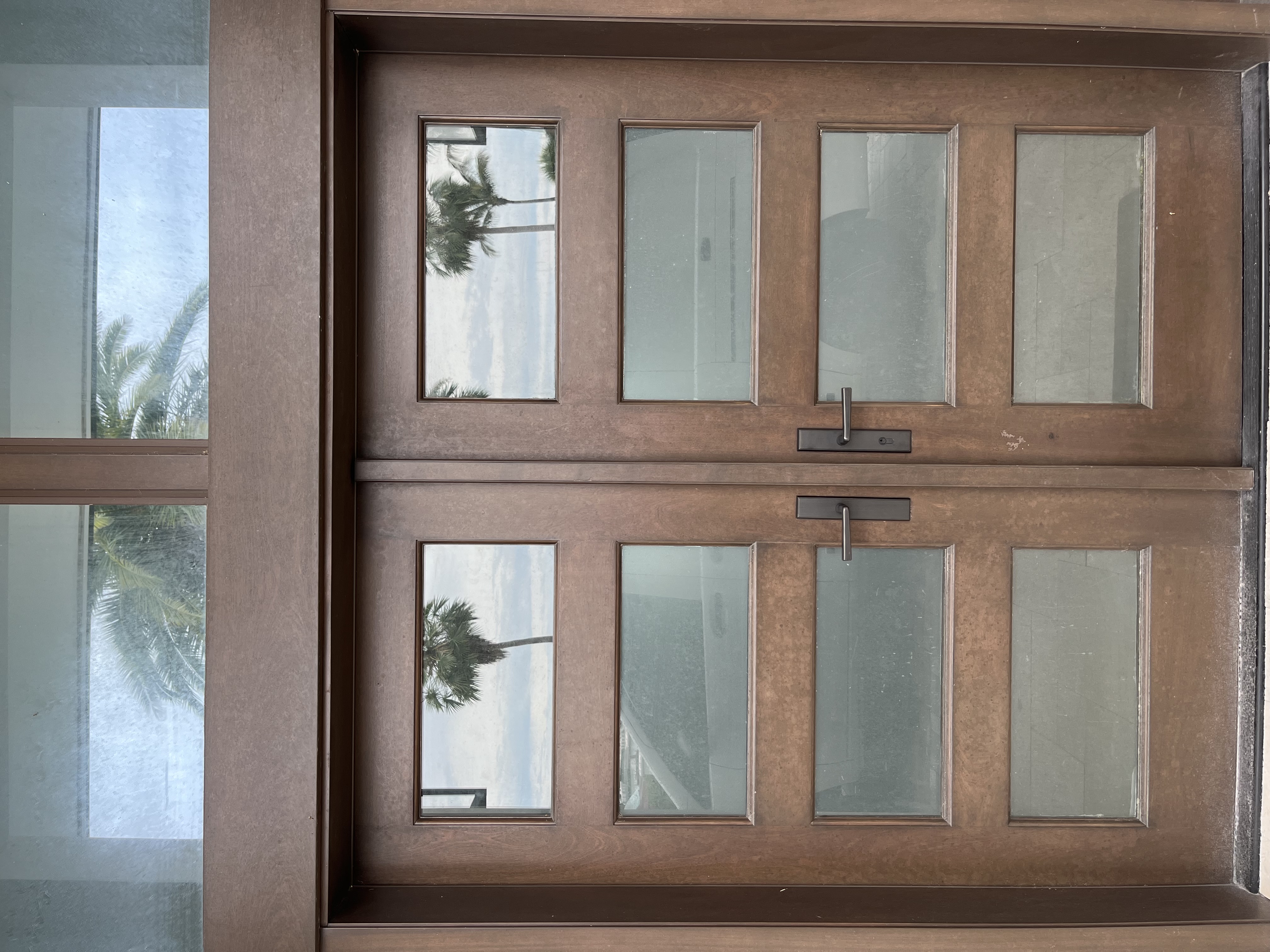 Beautiful double glass-panel entry doors with bronze levers installed by Lockhart Locksmith in Sarasota